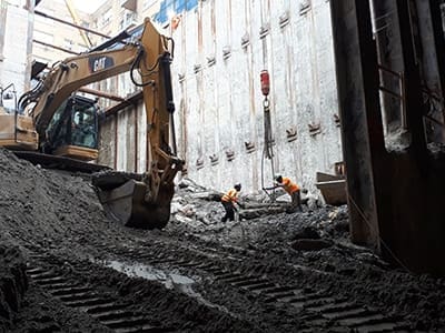 workers in a deep excavation site