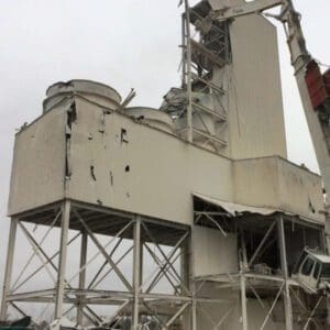 Industrial demolition project featuring high reach equipment.