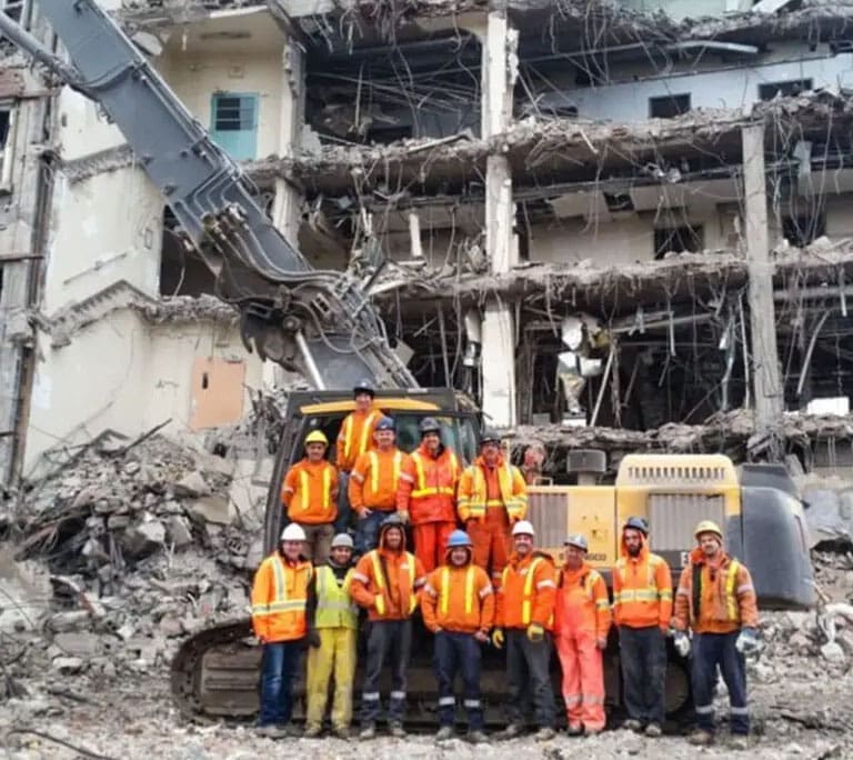 Proud employees posing in front of a YORK1 demolition project.