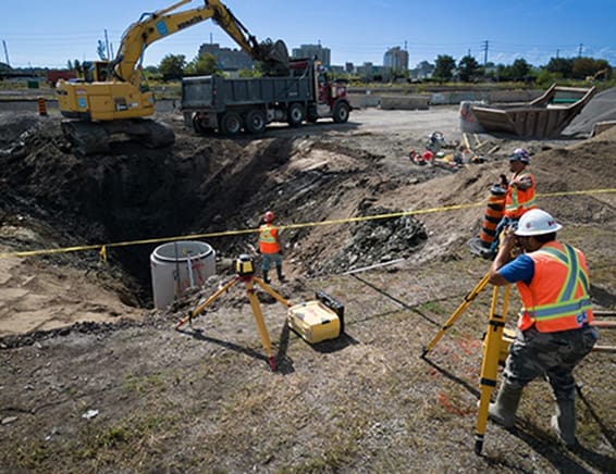 Expert grading and earthworks in progress, featuring dedicated employees and heavy machinery on the construction site.