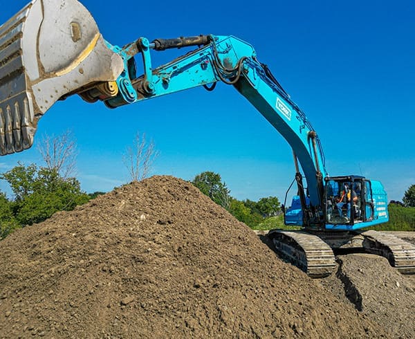 Excavator moving dirt.