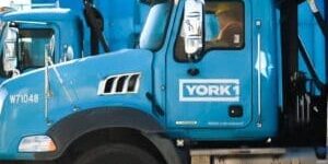 a line up of YORK1 roll off trucks